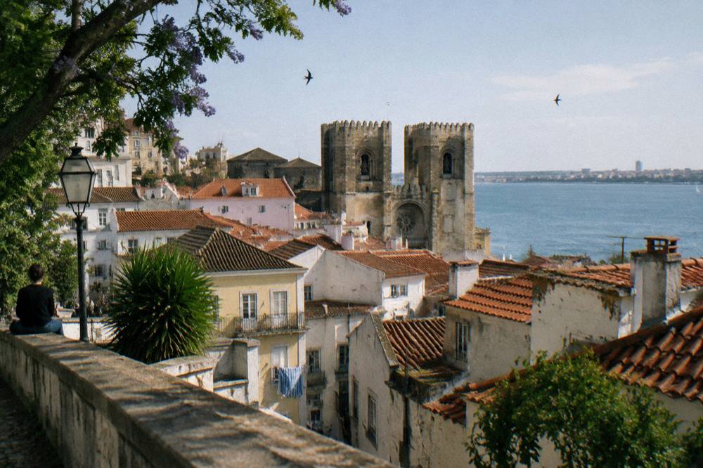 Viewpoint over Lisbon cathedral rooftops under a mild clear sky